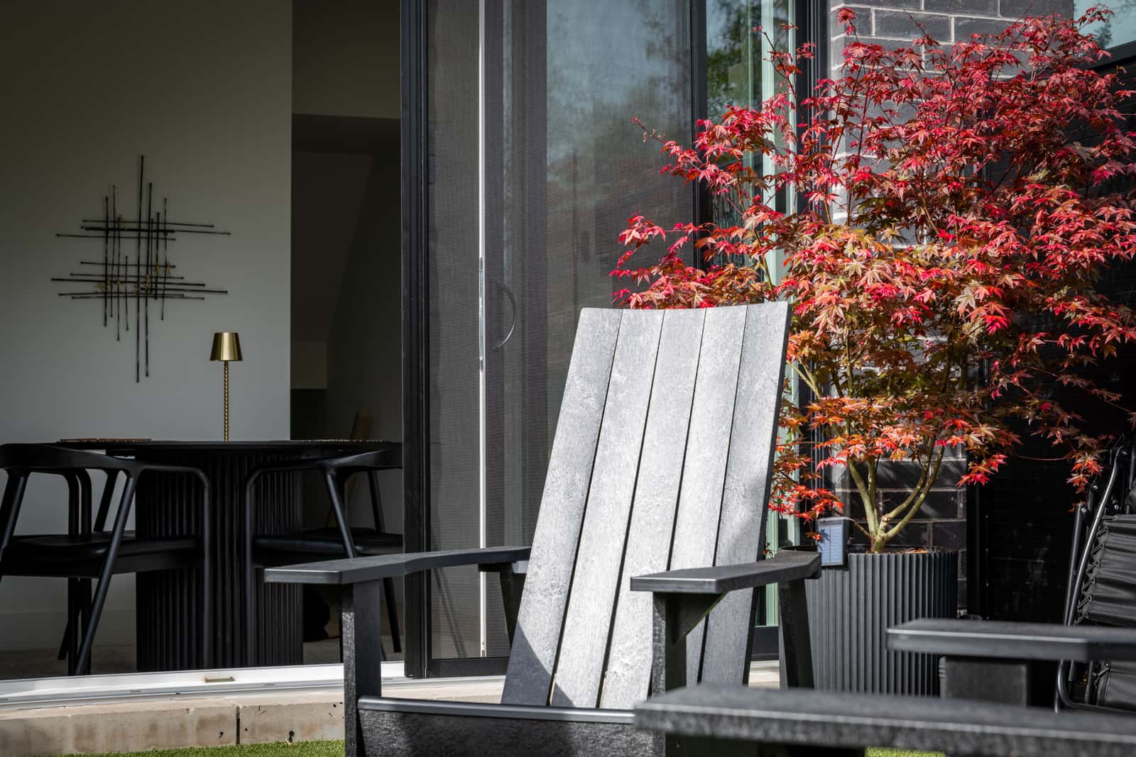 An Adirondack chair on a wooden deck