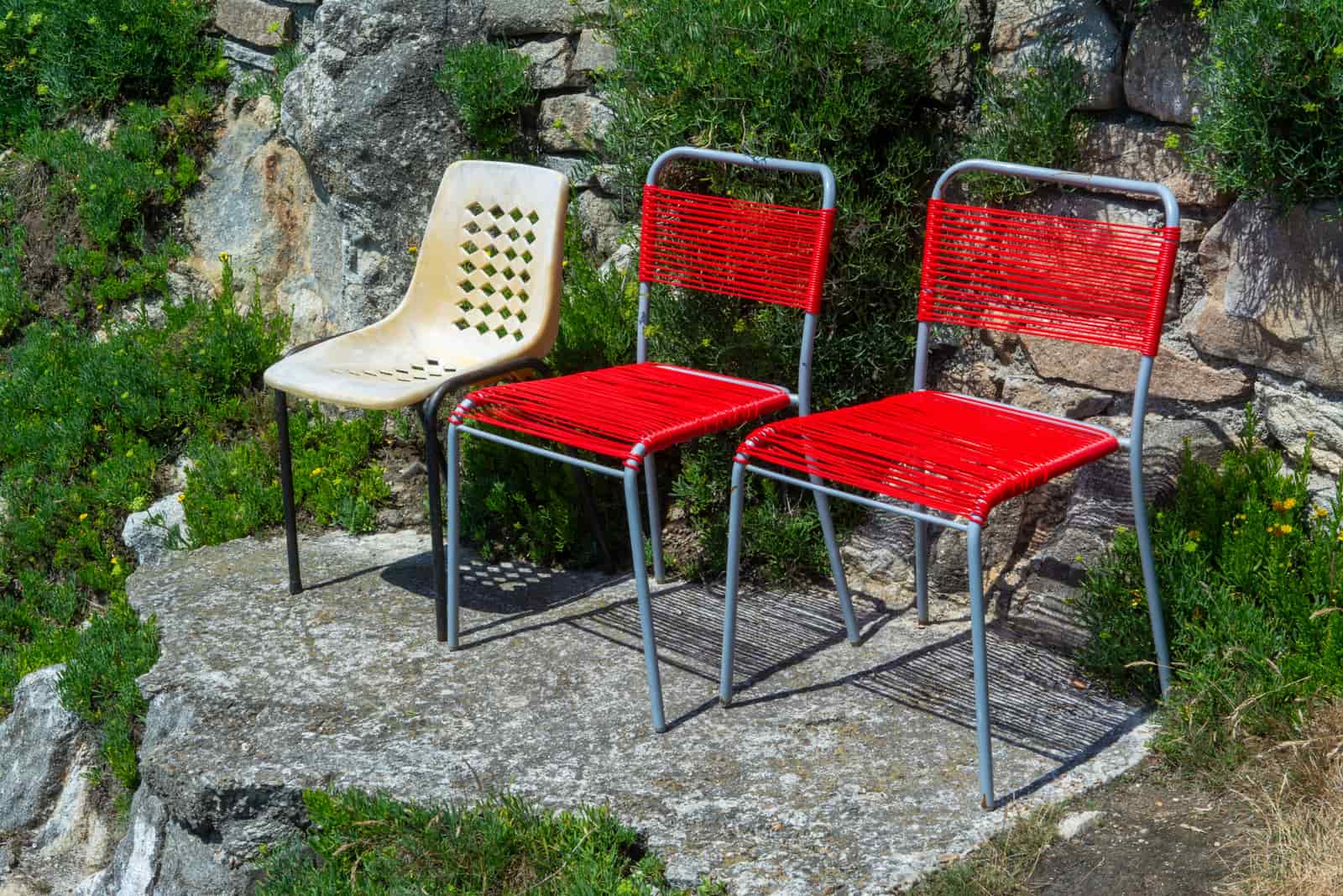 Brightly colored poly lumber chairs in a garden