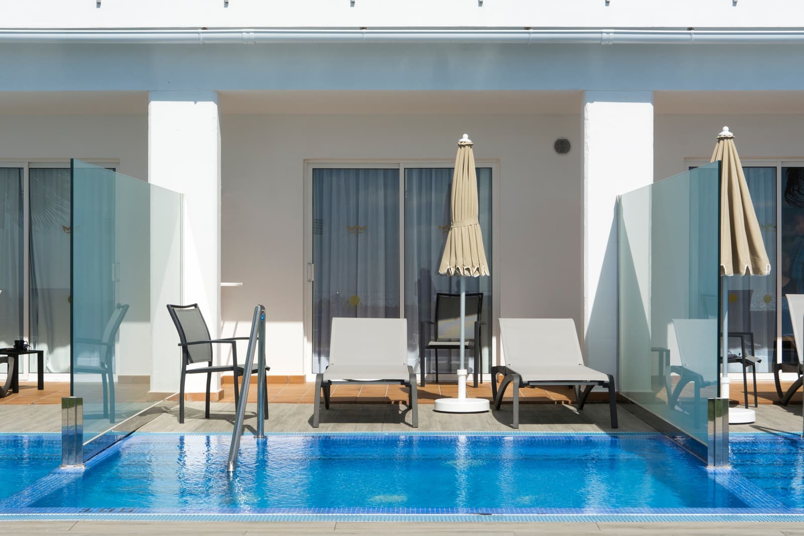 A sun lounger beside a swimming pool