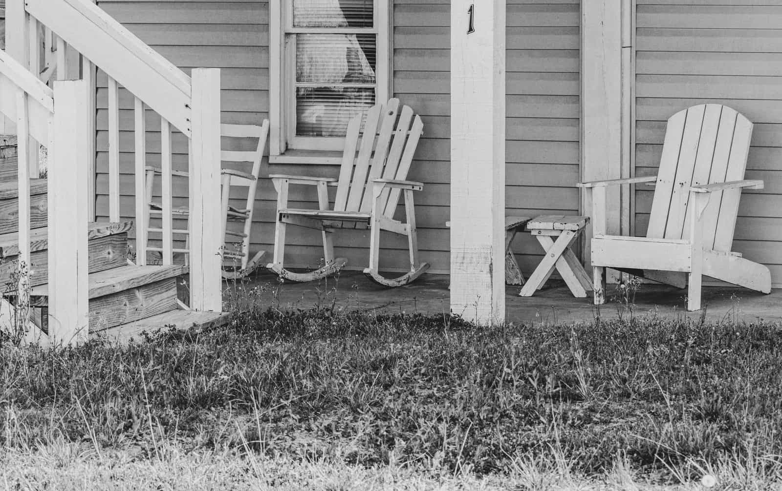 A rocking chair on a covered porch